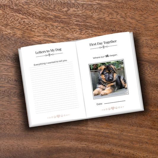 Opened minimalist pet memorial journal showing pages on a wooden table