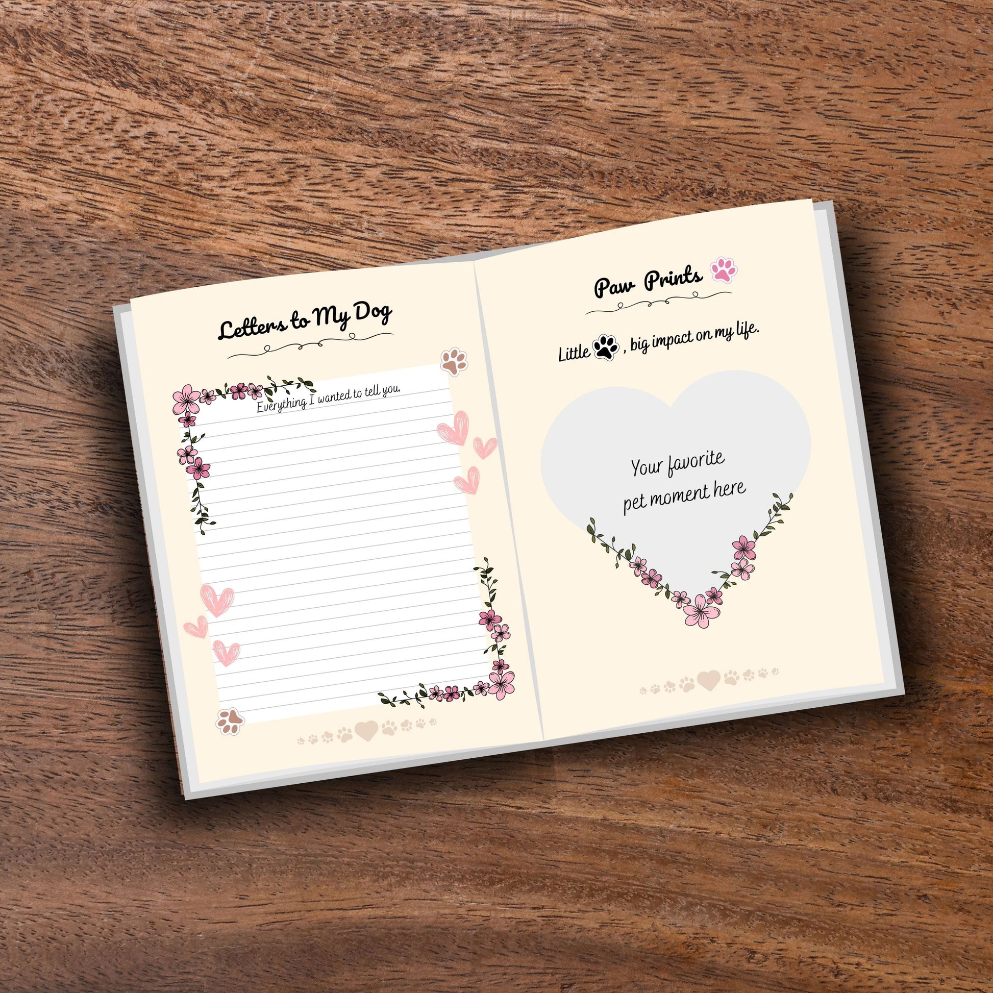 Opened decorated pet memorial journal showing customizable pages on a wooden table